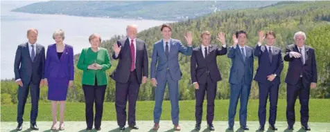  ?? — AFP ?? G7 leaders pose for the family photo during the G7 summit on Friday in La Malbaie, Canada. From left are: European Council President Donald Tusk, British Prime Minister Theresa May, German Chancellor Angela Merkel, US President Donald J Trump, Canadian...