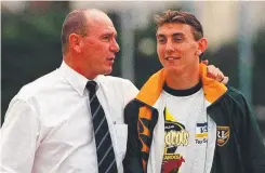  ?? Main photo: Mark Sullivan-bradley ?? Mat Rogers has released his book, A Father’s Son
Left: Mat Rogers holds the Bledisloe Cup in 2002; and, with his late father, former Cronulla Internatio­nal
Steve Rogers