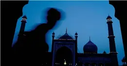  ?? — PTI ?? People gather to break their fast on the last day of Ramzan at Jama Masjid in New Delhi on Friday.