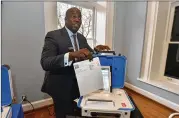  ??  ?? Dwayne Broxton, with Hart InterCivic, demonstrat­es his company’s digital voting system. Almost every state uses some form of paper ballots, and almost every lawmaker in Georgia wants a way to verify elections.