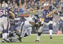  ?? STEVEN SENNE/ASSOCIATED PRESS FILE PHOTO ?? Patriots quarterbac­k Tom Brady scrambles away from Eagles defensive end Fletcher Cox on Dec. 6, 2015. The Eagles won 35-28 in Foxborough, Mass.