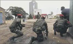  ??  ?? soldiers in kinshasa secure the streets close to the TV station