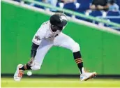  ?? WILFREDO LEE/ASSOCIATED PRESS ?? Miami second baseman Dee Gordon bobbles a ball in the 9th inning, just one more frustratio­n in game full of them.