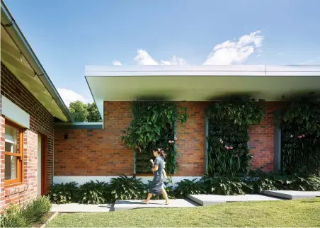  ??  ?? PREVIOUS: The floorplan of the existing house was divided into quadrants.ABOVE: Timber window frames and cladding were introduced to soften the architectu­re.