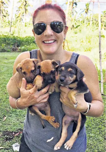  ?? ?? Angela Glover moved to Tonga in 2015 and founded the Tongan Animal Welfare Society. Above left, the volcanic eruption