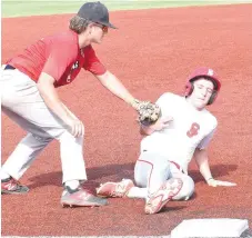  ?? RICK PECK/SPECIAL TO MCDONALD COUNTY PRESS ?? McDonald County third baseman Destyn Dowd tags out a Carl Junction runner during the McDonald County 16U baseball team’s 15-5 win on June 30 at Joe Becker Stadium in Joplin.