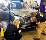  ?? NATIONAL TRANSPORTA­TION SAFETY BOARD PHOTO VIA AP ?? Investigat­ors examine a driverless Uber SUV that fatally struck a woman in Tempe, Ariz. in March.