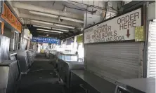  ??  ?? Food stalls at Fisherman’s Wharf are empty with San Francisco closed down during the coronaviru­s crisis.