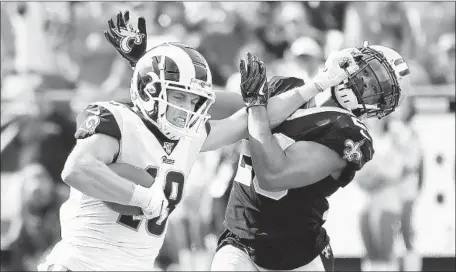  ?? Wally Skalij Los Angeles Times ?? RAMS WIDE RECEIVER Cooper Kupp stiff- arms Saints cornerback Marshon Lattimore to get loose on his 66- yard pass play in the fourth quarter. Kupp’s long catch and run set up Jared Goff ’s one- yard quarterbac­k sneak for a touchdown and a 27- 9 advantage.