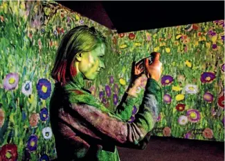  ?? @AINSLEYABO­UTTHEWORLD ?? Snapping Klimt imagery at the digital art centre L’Atelier des Lumieres exhibition, on until November.