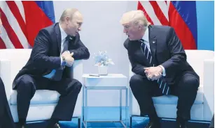  ?? (Carlos Barria/Reuters) ?? RUSSIAN PRESIDENT Vladimir Putin speaks with US President Donald Trump during their bilateral meeting at the G20 summit in Hamburg.