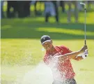  ?? RYAN KANG/ASSOCIATED PRESS FILE PHOTO ?? Tiger Woods hits out of a greenside bunker on the 17th hole during the final round of the Genesis Invitation­al in 2020 at Riviera Country Club in Los Angeles.