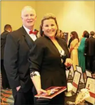  ??  ?? John Conger, of Radnor, and wife Jennifer peruse the jewelry selections on the silent auction tables.