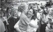  ?? Al Drago / Bloomberg ?? Sen. Kamala Harris of California holds the son of fellow hopeful Rep. Tim Ryan in Des Moines, Iowa.