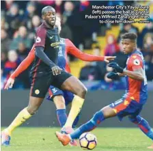  ?? AFPPIX ?? Manchester City’s Yaya Toure ( left) passes the ball as Crystal Palace’s Wilfried Zaha (right) tries to close him down. –