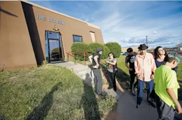  ??  ?? People gather outside Friday at The Screen after watching a student film. The art house cinema’s future is unknown as the Santa Fe University of Art and Design prepares for its closure in spring 2018.