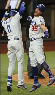 ?? (AP/Eric Gay) ?? Cody Bellinger (right) celebrates his go-ahead home run with A.J. Pollock in the bottom of the seventh inning against the Atlanta Braves during Game 7 of the National League Championsh­ip Series. Bellinger’s home run broke a 3-3 tie and lifted the Dodgers to a 4-3 victory.