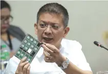  ?? PHOTO COURTESY OF SENATE ?? SENATOR Francis G. Escudero, chair of the Senate Committee on Banks, Financial Institutio­ns and Currencies, holds up a sample of an ATM keypad during his committee’s inquiry on Wednesday.