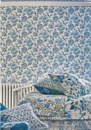  ?? ?? TRUE BLUE: English garden floral delft wallpaper, £65; fabrics £65-£75 a metre; cushions £65-£75, Designers Guild.