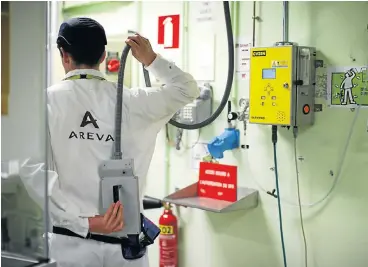  ?? /Reuters ?? Bankrupt sector: A technician checks for radiation levels after leaving the nuclear zone at the Areva Nuclear Plant for the treatment of nuclear waste at La Hague, near Cherbourg, western France.