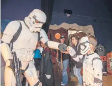  ?? ?? Reece Read, 6, fist bumps his fellow Storm Trooper at last year’s event