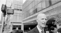  ?? MICHAEL MCANDREWS/THE HARTFORD COURANT VIA AP ?? Gov. Rick Scott talks to the media before heading to a meeting with Hartford, Conn., business owners at the Hilton Hotel on Thursday.
