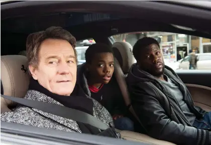  ?? STX FILMS ?? Actors Bryan Cranston, left, Jahi Di’Allo Winston, and Kevin Hart star in The Upside, which, despite poor reviews, managed to surpass expectatio­ns and debut at the top of the North American box office, pushing the superhero movie Aquaman into second place.