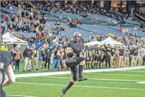  ?? Tim Godbee ?? Calhoun High School senior Quin Smith pulls in a reception against Warner Robins.