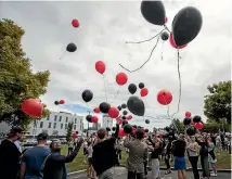  ?? PHOTO: GEORGE HEARD/FAIRFAX NZ ?? Balloons in Canterbury colours are released at the CTV memorial site where 115 people died.