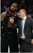  ?? AP file photo ?? Cleveland Cavaliers Coach Tyronn Lue (right) plans to have dinner in the near future with Los Angeles Lakers Coach Luke Walton. New Laker LeBron James (left) is expected to be the major topic of discussion.