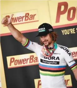  ??  ?? VERVIERS: Stage winner Slovakia’s Peter Sagan celebrates on the podium after winning at the end of the 212.5 km third stage of the 104th edition of the Tour de France cycling race yesterday between Verviers, Belgium and Longwy, France. — AFP