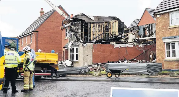  ??  ?? Devastatin­g Mr McGuigan’s property partially collapsed following the explosion and ensuing fire