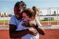  ??  ?? Trainee Beauxeryka­h Betterson, left, hugs Kassidy Jackson, her friend and a member of her basic training “flight,” after learning that they passed their final physical training tests.