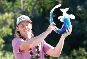  ?? AP Photo/Matt York ?? ■ Cameron Smith holds the champions trophy Sunday after the final round of the Tournament of Champions golf event at Kapalua Plantation Course in Kapalua, Hawaii.