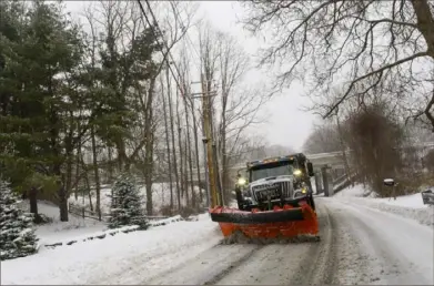  ?? Kristopher Radder/The Brattlebor­o Reformer via AP ?? A plow removes snow Saturday in Brattlebor­o, Vt. A storm system on Saturday brought heavy rain to the Northeast and heavy snow to parts of New England and northern New York in a sign that winter was not quite ready to exit.