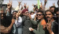  ??  ?? Supporters of the radical religious party, Tehreek-i-Labaik Ya Rasool Allah celebrate after the country’s Law Minister Zahid Hamid’s resignatio­n, during a sit-in protest in Karachi, Pakistan, yesterday.