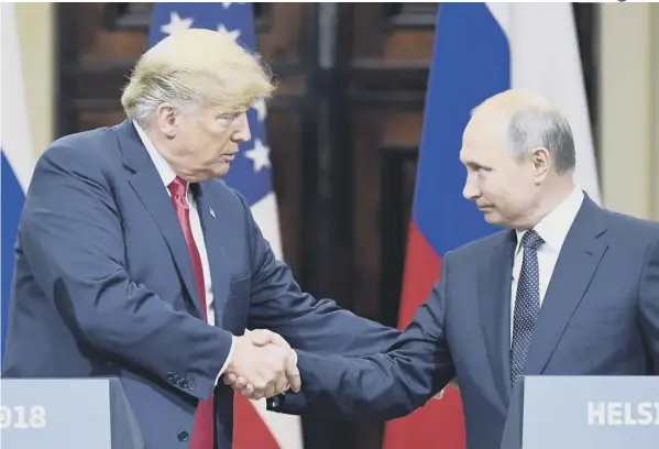  ??  ?? 0 The eyes have it: Donald Trump and Vladimir Putin shake hands during a joint press conference after a meeting in Helsinki