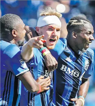  ?? JOHN MAHONEY ?? Impact defender Kyle Fisher, centre, celebrates his goal with Anthony Jackson-Hamel, left, and Ambroise Oyongo on Saturday. Fisher had to get six stitches over his eye following a collision with a Portland player.