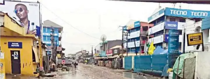  ??  ?? An empty street and locked shops in Onitsha during a sit- at- home order by IPOB... recently