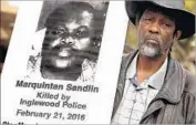  ?? Genaro Molina Los Angeles Times ?? MILTON FAULKNER holds a poster of his son Marquintan Sandlin, who was killed in the 2016 incident.