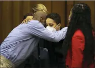  ?? CHRISTIAN GOODEN/ST. LOUIS POST-DISPATCH VIA AP, POOL ?? Lamar Johnson, left, embraces St. Louis Prosecutor Kim Garner on Tuesday, Feb. 14, 2023, after St. Louis Circuit Judge David Mason vacated his murder conviction during a hearing in St. Louis, Mo. Johnson served nearly 28years of a life sentence for a killing that he has always said he didn’t commit.