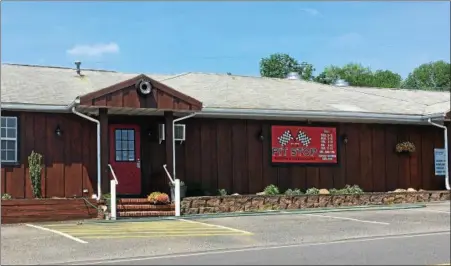  ?? MONICA SAGER — DIGITAL FIRST MEDIA ?? The Pit Stop Tavern &amp; Restaurant in Boyertown has been renovated and is under new ownership — and began service customers in May. The restaurant is maintainin­g its racing theme, and steaks are still a staple on the menu.