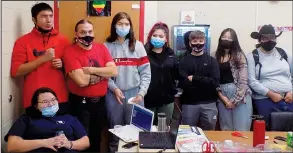  ?? (AP/Rapid City Journal/Michael Neary) ?? Lakota Studies teacher Will Peters (third from left) stands Dec. 11 with his Lakota Language and Culture students at Pine Ridge High School in Pine Ridge, S.D.