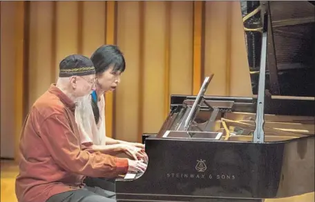  ?? Allen J. Schaben Los Angeles Times ?? TERRY RILEY and Gloria Cheng perform a piece for piano four-hands that was written for the occasion at at Zipper Concert Hall.