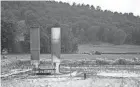  ?? COURTNEY HERGESHEIM­ER/ COLUMBUS DISPATCH ?? A farmer bails hay right next to a well pad in Guernsey County. Applicatio­ns have come in to frack beneath Salt Fork State Park.