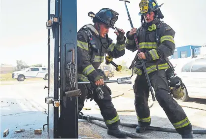  ?? Joe Amon, The Denver Post ?? Firefighte­rs Kaleb Staley, left, and Sam Noyes train at the Platte Valley Fire Protection District training facility in Kersey on Thursday. The district will use severance funds to begin an upgrade next month on its facility.