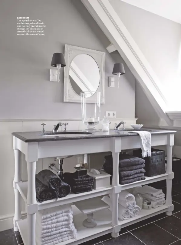  ??  ?? BATHROOM
The open shelves of the marble-topped washbasin unit not only provide useful storage, but also make an attractive display area and enhance the sense of space.