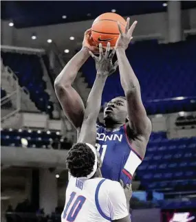  ?? Charles Rex Arbogast/Associated Press ?? UConn’s Adama Sanogo shoots over DePaul’s Yor Anei during the first half on Tuesday in Chicago.