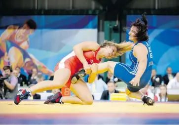  ?? MATT ZAMBONIN/THE CANADIAN PRESS ?? University of Calgary student Erica Wiebe of Stittsvill­e takes down Gozol Zuova of Azerbaijan in the women’s 72-kilogram wrestling bronze-medal match Saturday. ‘This day was awesome,’ Wiebe said after the event in Kazan, Russia.