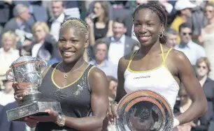  ?? FRANCOIS MORI/ASSOCIATED PRESS FILE ?? Serena Williams, left, and her sister Venus hold their trophies after the women’s final of the French Open at Stade Roland Garros in Paris on June 8, 2002. Serena won 7-5, 6-3 for her second major championsh­ip.